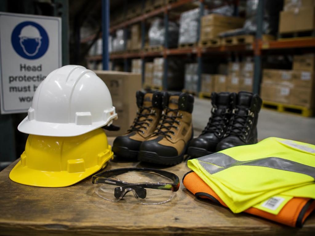 Hard hats, hi-vis, safety footwear and eye protection in a warehouse